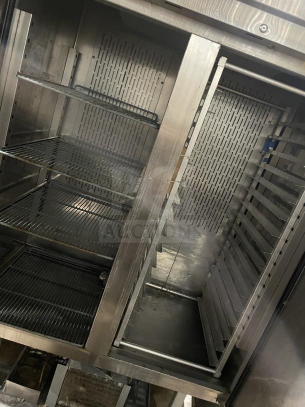 Kelvinator commercial stainless steel 2-door refrigerator, poly-coated wire racks, 115V, on casters, good condition.