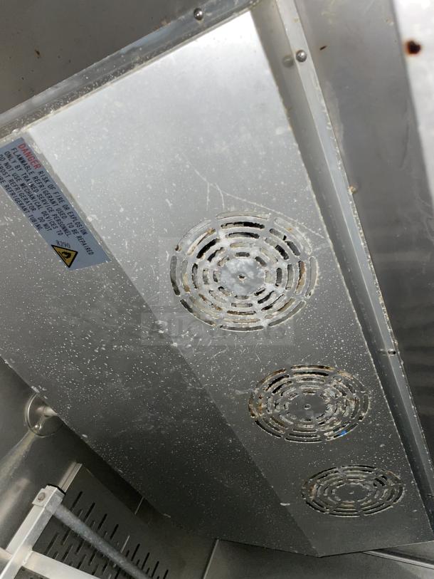 Kelvinator commercial stainless steel 2-door refrigerator interior, showing poly-coated wire racks and vents. Visible tag highlights R290 use.