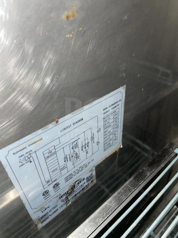 Kelvinator stainless steel 2-door refrigerator, poly-coated wire racks, 115V, 60HZ. Circuit diagram and model details visible.