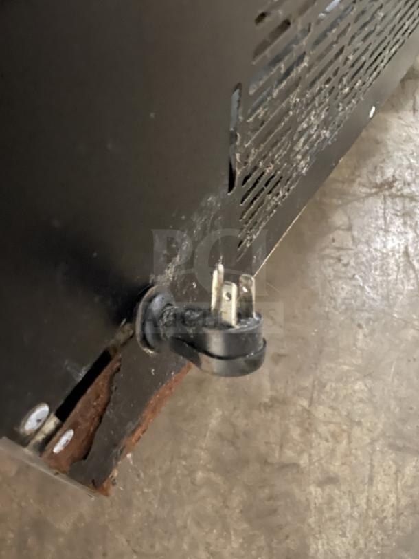 Kelvinator commercial 2-door stainless steel refrigerator on casters, features poly-coated wire racks, 115V. Visible plug and minor wear.