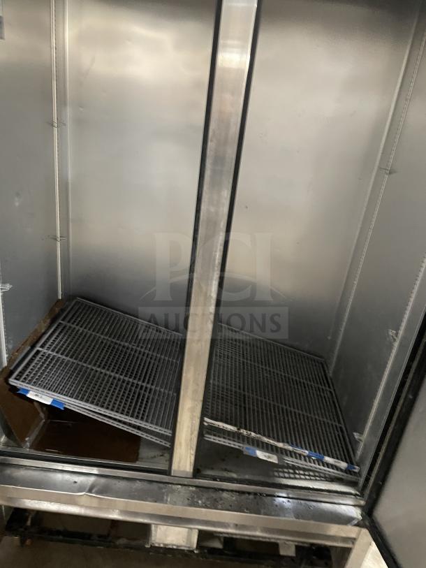 True T-43-HC commercial stainless steel 2-door refrigerator, with poly-coated wire racks and casters, in good condition.