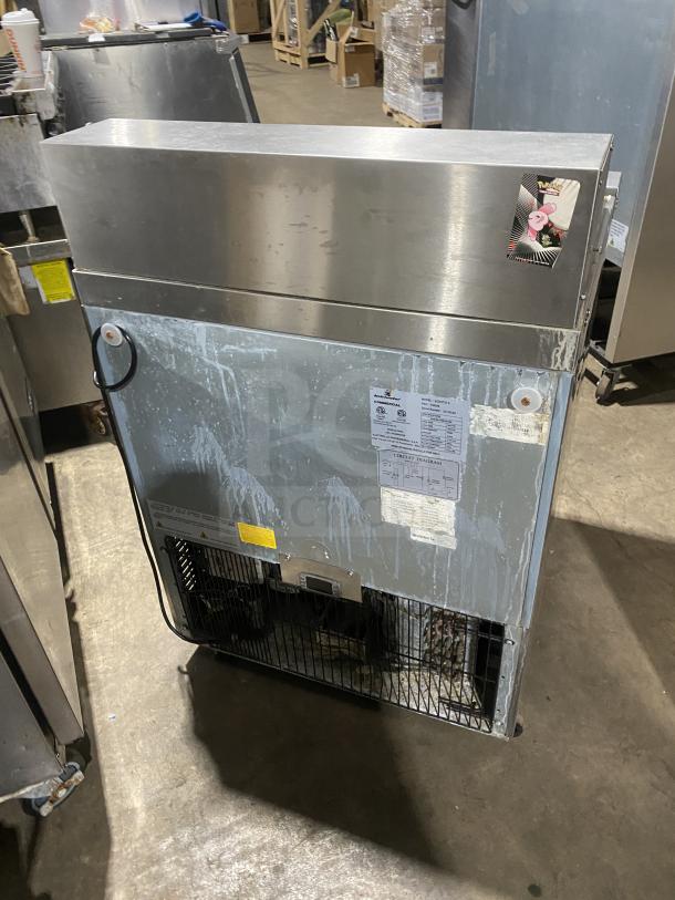Kelvinator Commercial Stainless Steel Single Door Refrigerated Bain Marie Prep Table, Model KCHST278, on casters, with wired rack. Serial Number: 32120092. Features power specifications and diagrams on label.