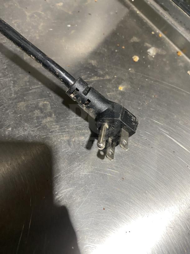 Power cord of Kelvinator Commercial Refrigerated Bain Marie Prep Table, Model KCHST278, shown on stainless steel surface.