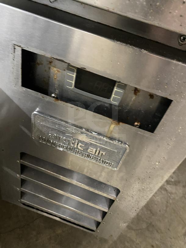 Arctic Air ARCB36Z stainless steel refrigerated chef base, model ARCB36Z, SN: H20007715, 115V, on casters. Rust visible.