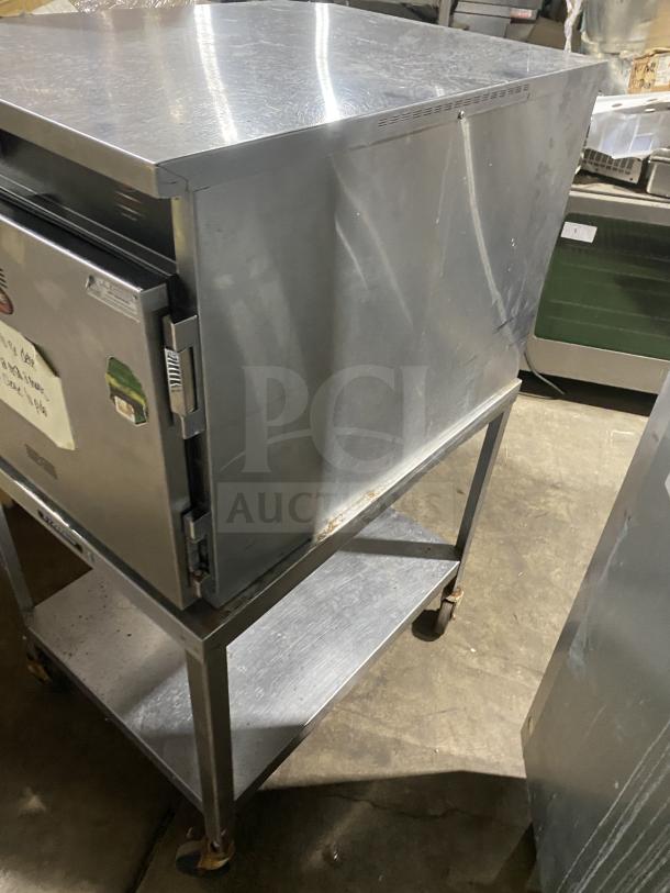 FWE Handy Line stainless steel 4-pan heated holding cabinet, Model HLC-1826-4-UC, on shelf stand with casters. Used condition.