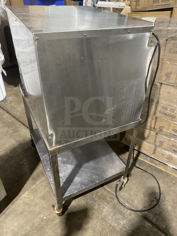 FWE Handy Line Series stainless steel heated holding cabinet, Model HLC18264UC, on single shelf stand with casters, 120V.