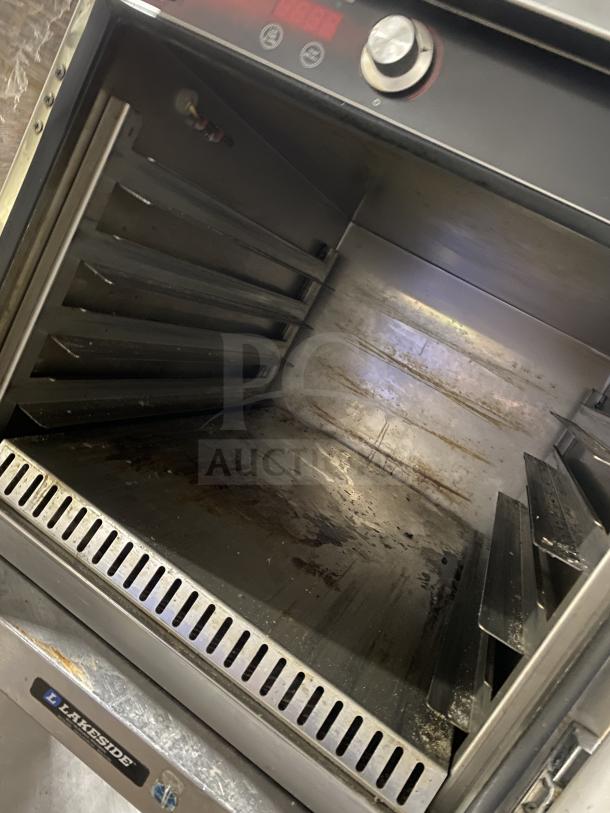 FWE Handy Line Series stainless steel 4-pan heated holding cabinet, model HLC18264UC, on casters and a single shelf stand.