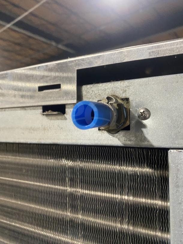 Hoshizaki KM660MAJ ice machine, stainless steel, showing air-cooled condenser detail with blue fitting, model KM-660MAJ.