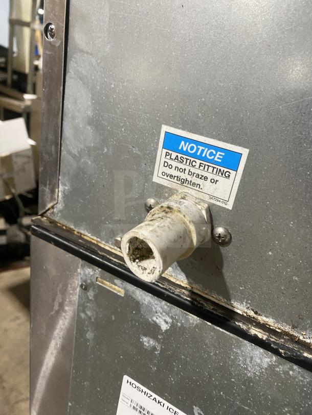 Hoshizaki KM-660MAJ ice machine with plastic fitting notice, stainless steel finish, commercial use, air-cooled model.