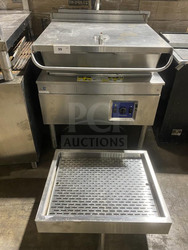 Cleveland stainless steel gas-powered tilt skillet on legs; includes control panel and safety labels; commercial-grade condition.