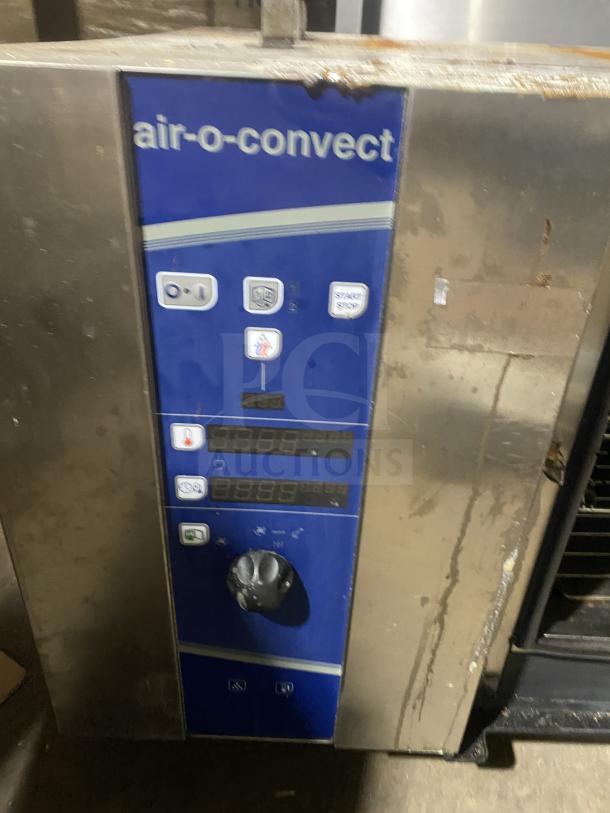 Electrolux Air-O-Convect stainless steel combi oven, natural gas, touchline controls, wired oven rack, on legs, visible wear.