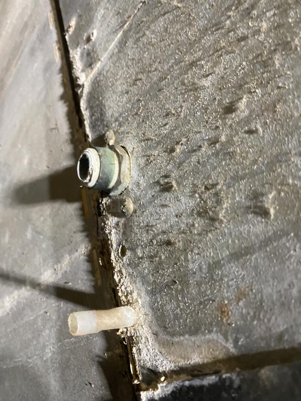 Close-up of a connection point on a Hoshizaki KM-901MAH ice machine showing wear.