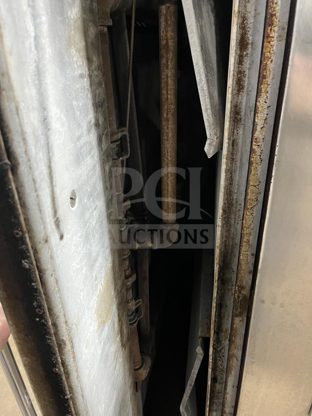 Bakers Pride Y602 pizza oven interior, showing gas pipes and rust. Commercial stainless steel double stacked model.