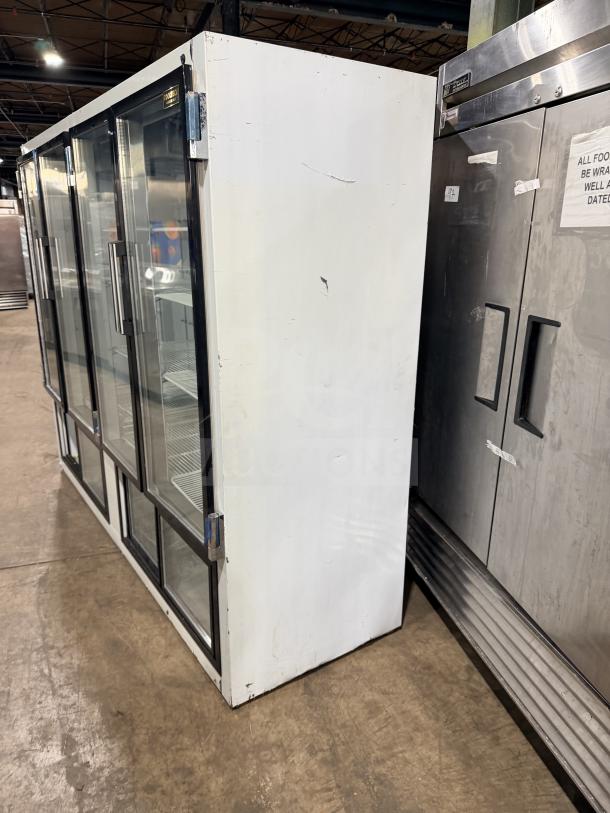 Cool Tech 4 Door Reach-In Cooler Merchandiser, Model CUST96PGR. Remote compressor, white exterior, visible wear.