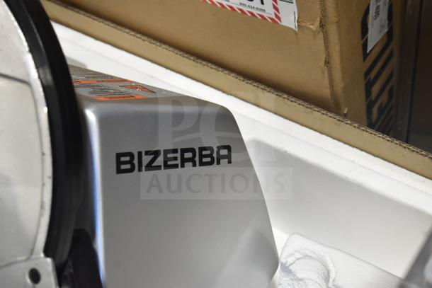 2025 Bizerba GSP H commercial meat slicer, 120 volts, 1 phase, sleek silver finish, clear brand marking on housing.