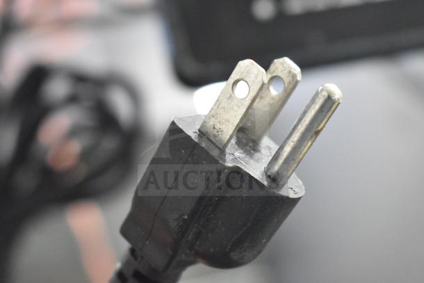 Close-up of a plug of the 2025 Hobart HTi-7LH4W commercial food portioning scale, showing its electrical connectivity.