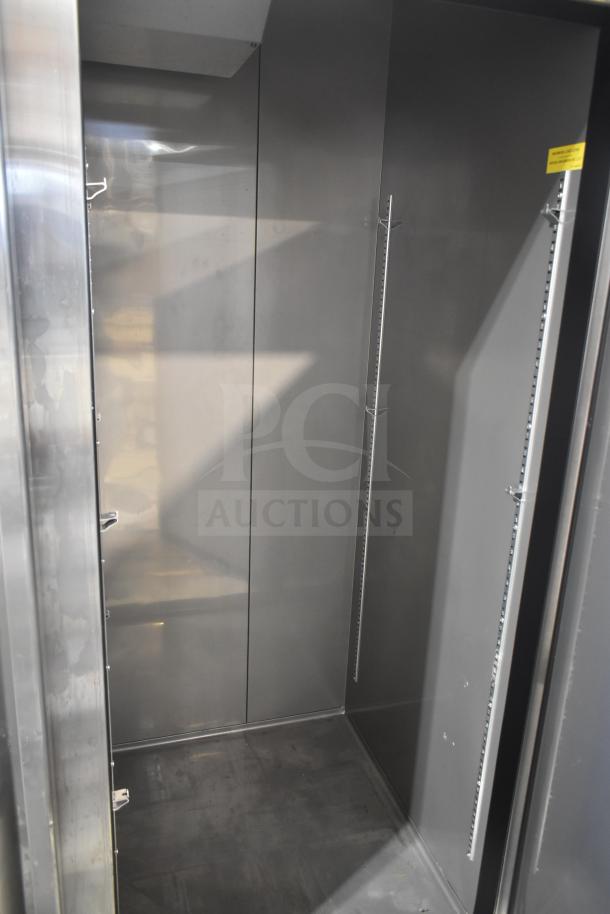 Alt text: "Avantco 447AP49R commercial 2 door reach-in cooler interior, scratch and dent, with shelving tracks."