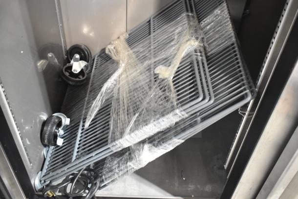 Avantco 447AP49R commercial reach-in cooler with casters, showing wrapped shelves inside. Brand new, scratch and dent.