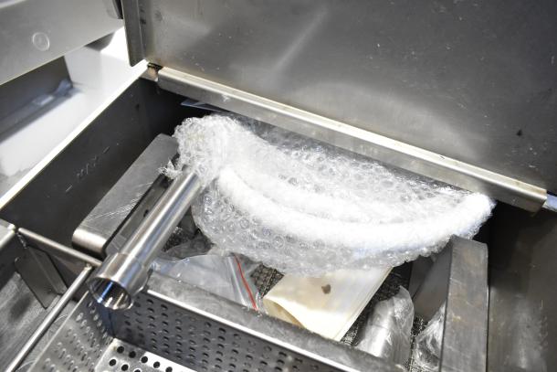 New Fryclone 259OFM55 fryer oil filter machine with accessories, bubble-wrapped and partially assembled. Scratches visible.