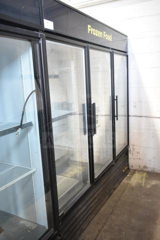 True GDM-72F-LD 3-door reach-in freezer merchandiser; black exterior, glass doors, shelves intact; for commercial use.