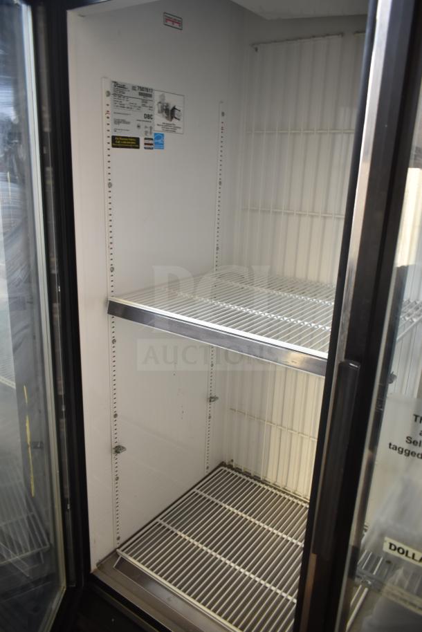 True GDM-72F-LD Commercial 3-Door Freezer Merchandiser, white interior, adjustable shelves, visible model label.