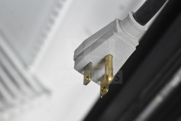 Close-up of the power plug on a 2017 True GDM-72-LD commercial cooler, showing electrical connection details.