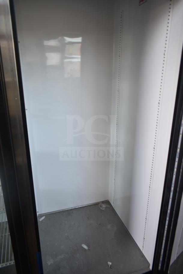 2018 True GDM-72-LD commercial 3-door reach-in cooler interior, white finish, power: 115/208-230 volts, 1 phase.