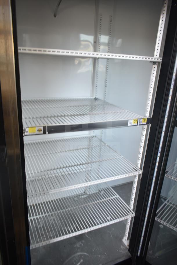 2018 True GDM-72-LD commercial 3-door reach-in cooler, white interior, adjustable shelving, 115/208-230V, excellent condition.