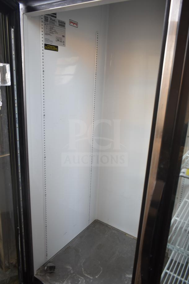 2018 True GDM-72-LD commercial cooler, 3-door reach-in, model label inside, white interior, used condition, 115/208-230 volts.