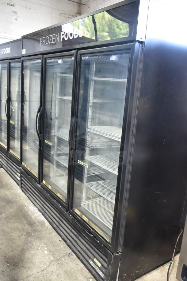 2018 True GDM-72F-LD commercial 3-door reach-in freezer merchandiser. Black exterior, glass doors, shelves visible, good condition.