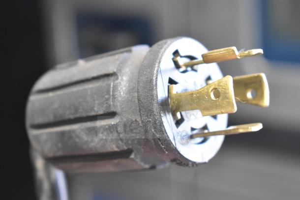 Close-up of a power plug for a 2018 True GDM-72F-LD Commercial Freezer, showing prongs and socket, in good condition.