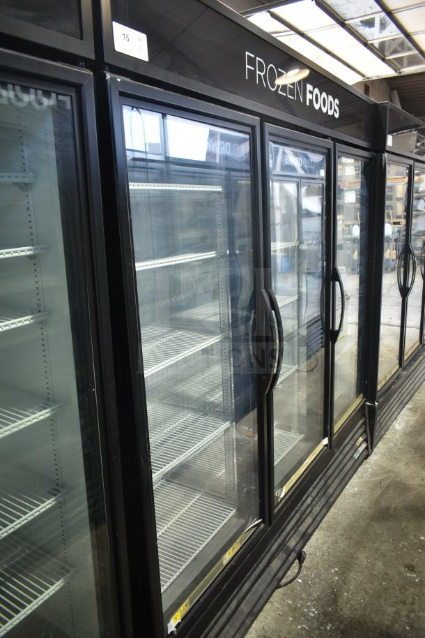 2018 True GDM-72F-LD 3 Door Reach-In Freezer Merchandiser, black frame, glass doors, shelves, "Frozen Foods" sign, good condition.