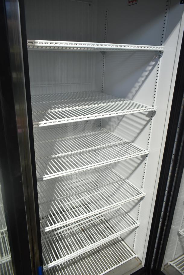 2018 True GDM-72F-LD commercial 3-door reach-in freezer, 115/208-230V, shelves visible, excellent condition.
