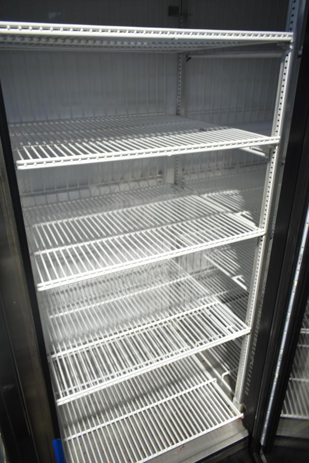 2018 True GDM-72F-LD commercial 3-door freezer merchandiser with spacious white wire shelves, excellent condition.