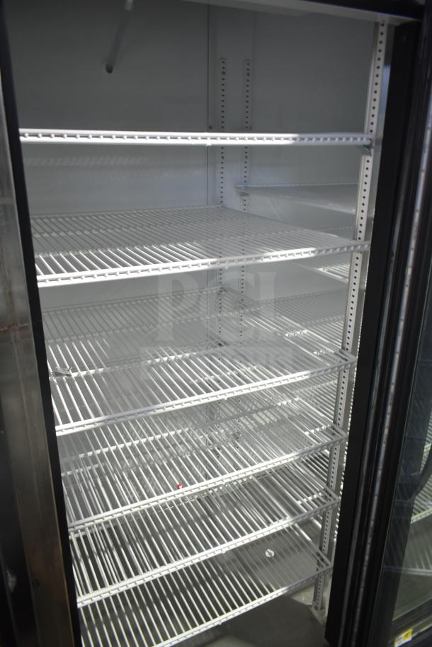 2018 True GDM-72-LD commercial 3-door reach-in cooler; features adjustable shelving, pristine interior, 115V, 1 phase.