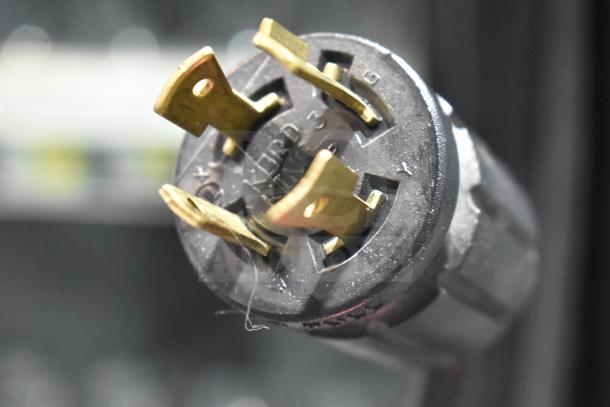 Close-up of a power plug for the 2020 True GDM-49F-LD commercial freezer. Gold prongs; durable build quality.