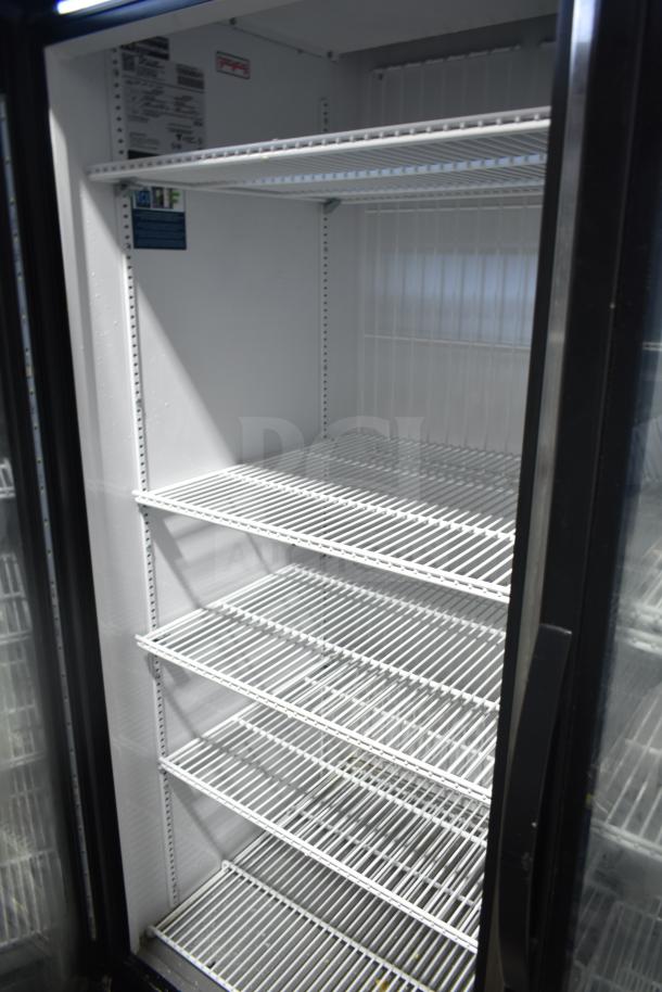 2020 True GDM-49F-LD commercial 2-door freezer, white interior with shelves. Model and voltage label visible.