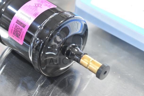 BRAND NEW Sanhua DTG-A08030-002 liquid line filter drier, scratch and dent condition, pink label, model and serial number visible.