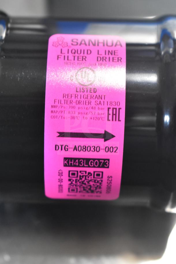 Brand new Sanhua DTG-A08030-002 liquid line filter drier, scratch and dent, pink label, model and specifications visible.