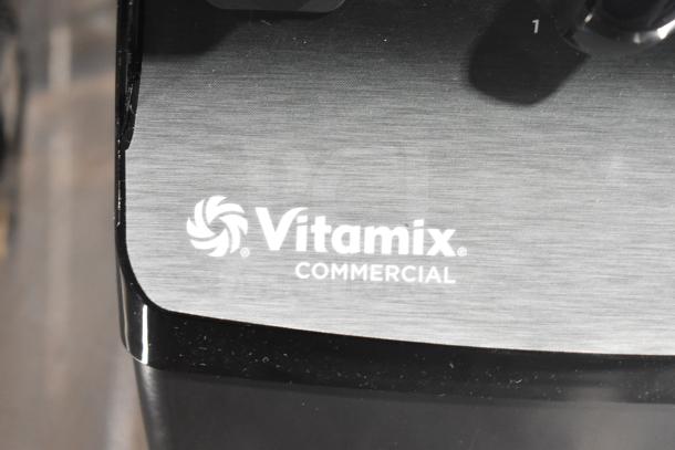 Close-up of the Vitamix Commercial VM0101 blender base with visible logo. Scratch and dent condition noted.