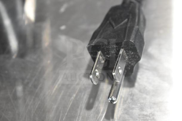 Close-up of a power plug for the Vita-Mix VM0101 blender, new condition, 120 volts, on a metallic surface.