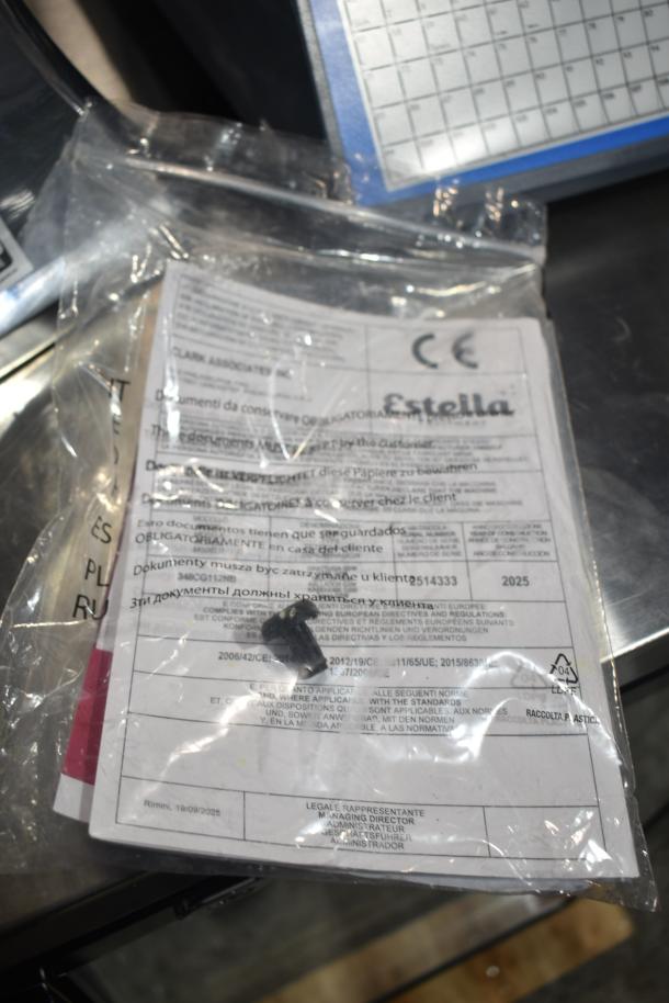 Brand new Estella 348CG112NB electric hard cheese grater, 3.3 lb/min capacity, 110V, shown with instruction packet.