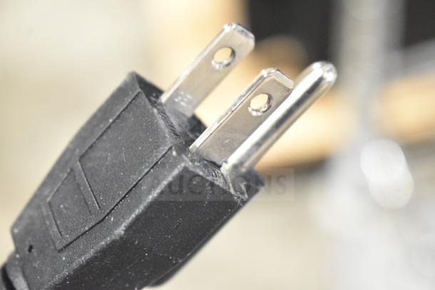 Close-up image of a power plug for the Backyard Pro MS-106119A meat slicer, 120V, 1 phase.