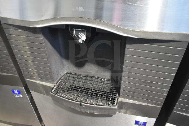Manitowoc Commercial Ice Machine Head on Hotel Ice Dispenser, 115V, 1 Phase, stainless steel, dispensing area with grate.