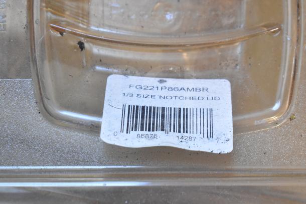 Amber colored drop-in bin lids, including models FG202P22AMBR, FG221P86AMBR. Visible notched label and barcode.