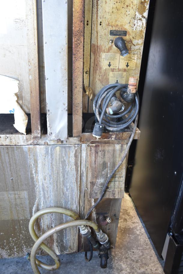 Two Alto Shaam CTP7-20G combi convection ovens, natural gas-powered, shown with cords and hoses. Well-used condition.