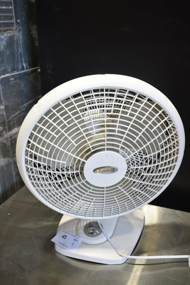 Lasko fan, white, 120 volts, 1 phase, in good condition, with visible brand label on the front grille.