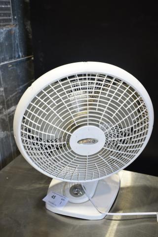 Lasko fan, white, 120 volts, 1 phase, in good condition, with visible brand label on the front grille.