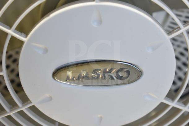 Lasko fan, 120 volts, 1 phase, white finish, visible logo on grille, used condition, reliable brand.