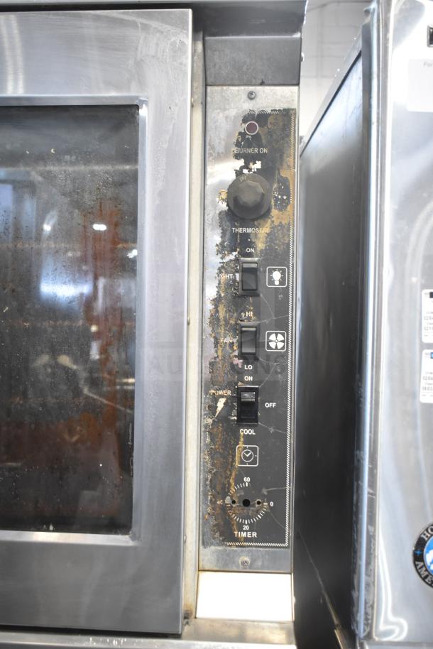 Royal commercial convection oven, view-through door, thermostatic controls on casters, visible wear on control panel.